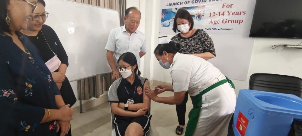 A health worker administers COVID-19 vaccine to Imsutula Jamir (14), the first beneficiary for the age group of 12 to 14 years in Dimapur district on March 16. The vaccination drive was launched by Dr I Moatemjen, Chief Medical Officer, Dimapur at the CMO’s conference hall. This age group of children will be administered with Corbevax vaccine. (Photo Courtesy: CMO Dimapur)